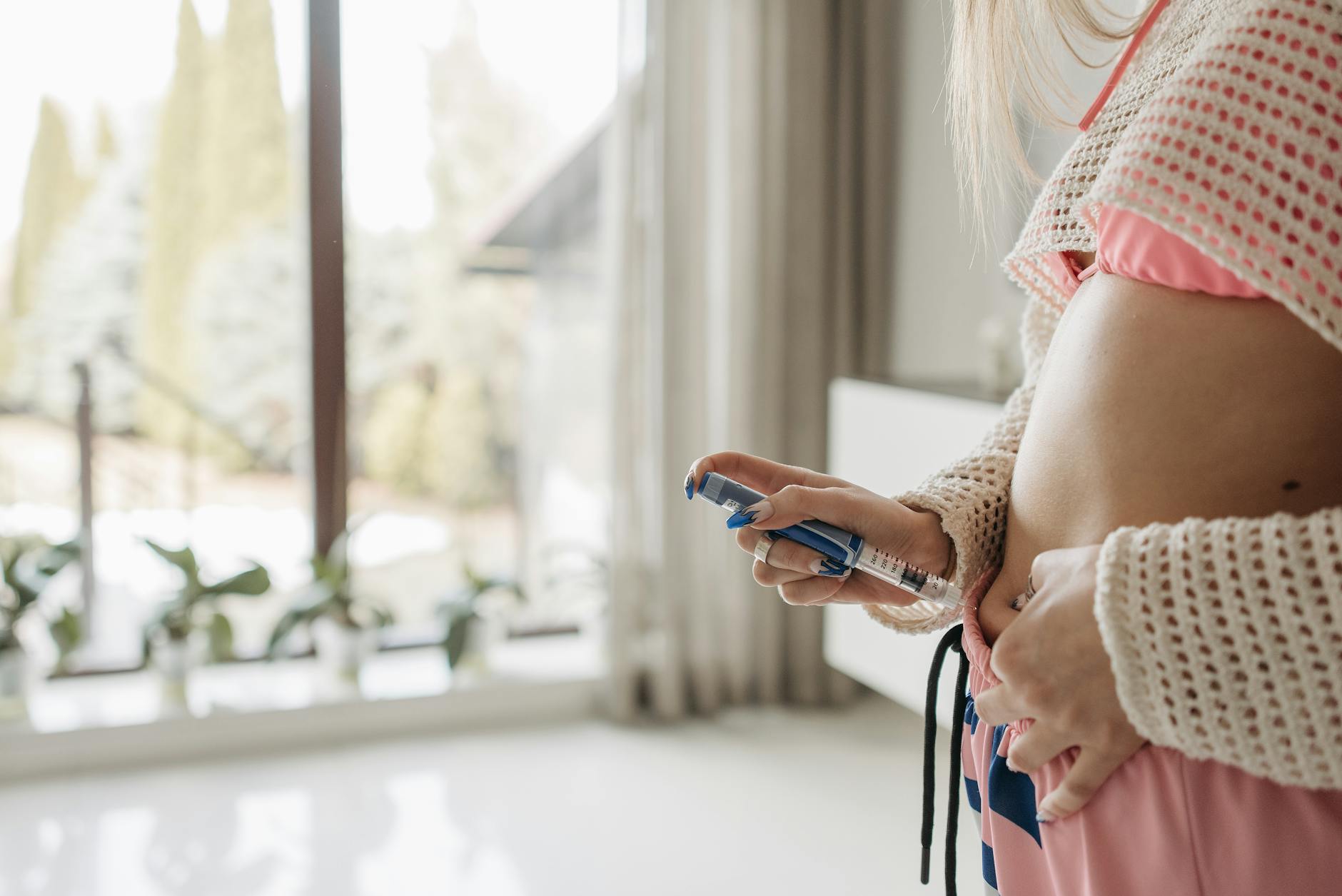 a woman using an insuling injection pen